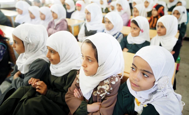Students listen to a teacher in class at a school in Yemen’s capital Sanaa on Monday. (Reuters)