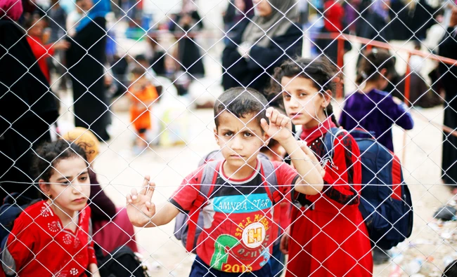Displaced Iraqis who had fled their homes are seen at Hammam al-Alil camp south of Mosul, Iraq on Tuesday. (Reuters)