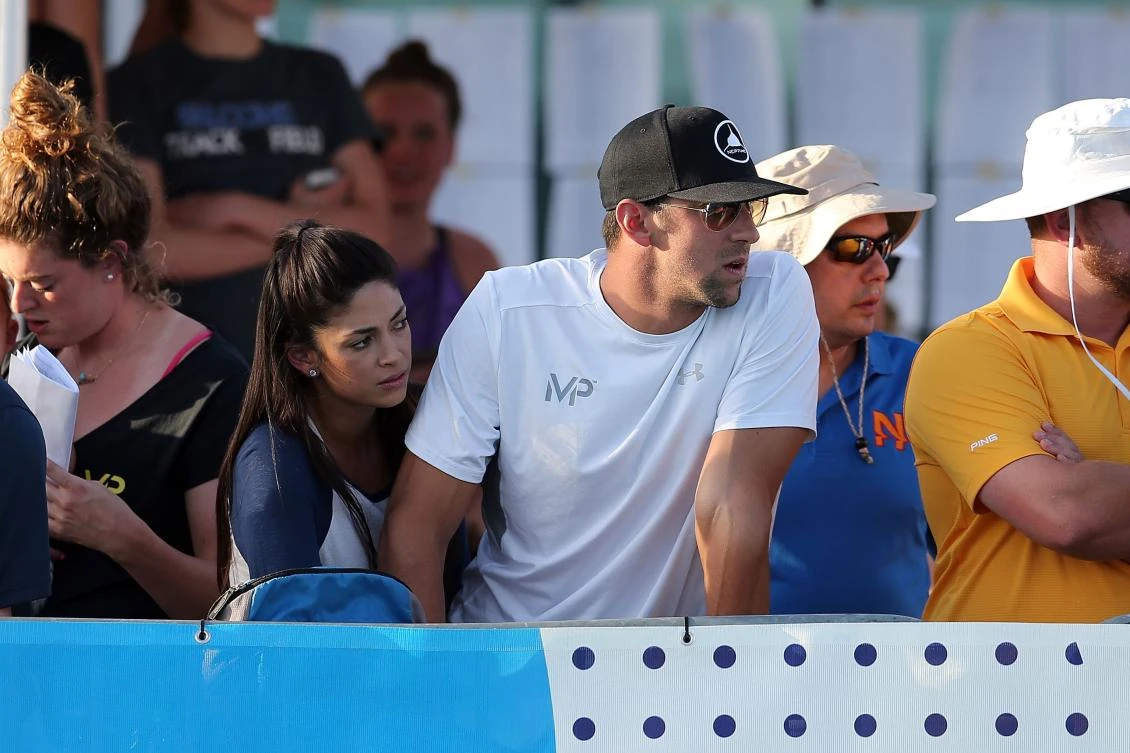 Michael Phelps and his wife Nicole watch a race on Day Two of the Arena Pro Swim Series-Mesa at Skyline Aquatic Center on Friday in Mesa, Arizona. (AFP)