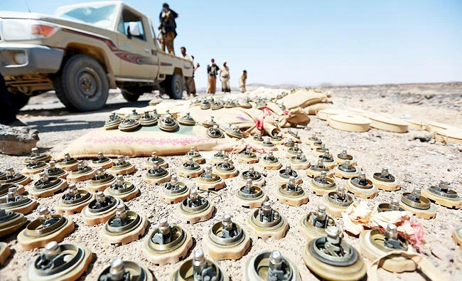 Soldiers loyal to Yemen's government stand next to mines planted by the Houthi rebels in locations where they controlled in frontline in the province of Marib, in this October 4, 2015 file photo. (REUTERS)