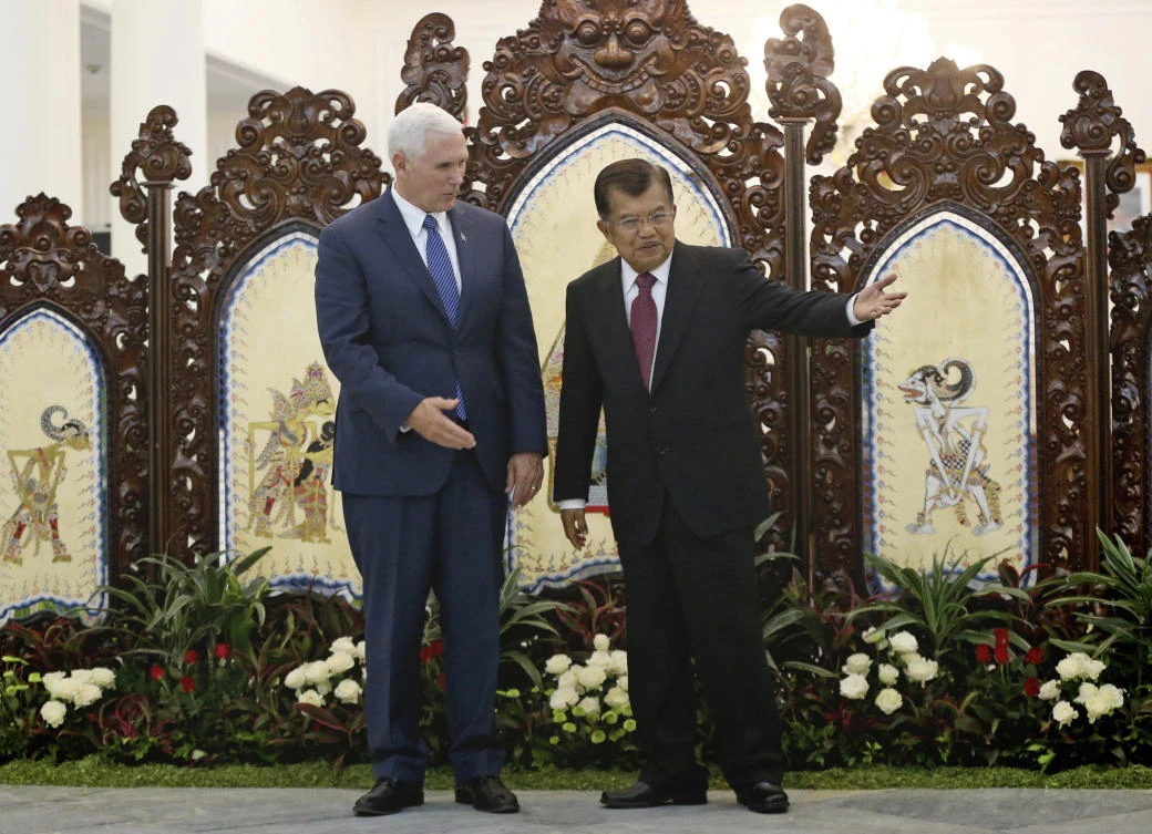 US Vice President Mike Pence, left, is greeted by his Indonesian counterpart Jusuf Kalla during their meeting in Jakarta, Indonesia. (AP)