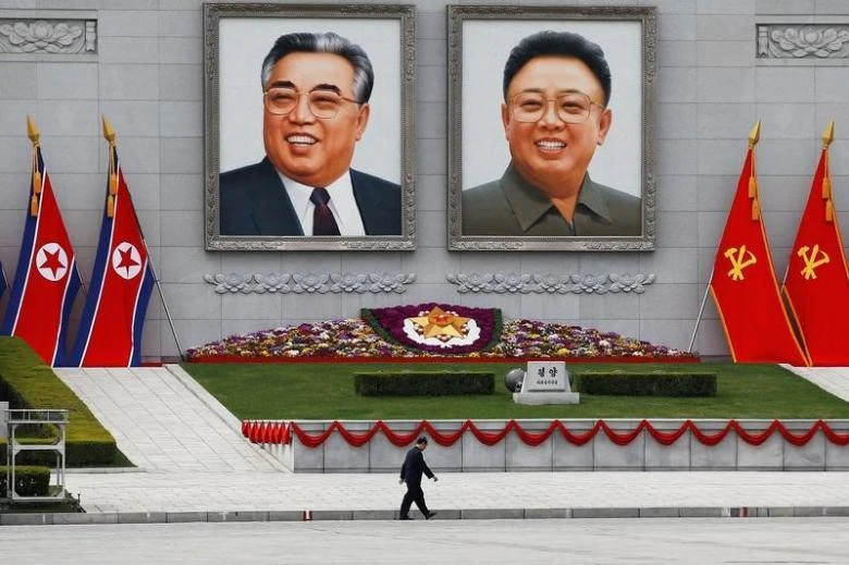 A man walks in front of portraits of North Korea founder Kim Il Sung and late leader Kim Jong Il in central Pyongyang, North Korea April 16, 2017. (REUTERS)