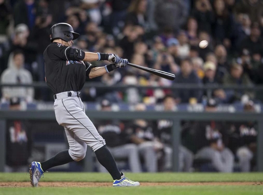 Ichiro Suzuki, of the Miami Marlins, hits a solo home run off of relief pitcher Evan Marshall, of the Seattle Mariners, during the ninth inning of a game at Safeco Field on Wednesday in Seattle, Washington. (AFP)