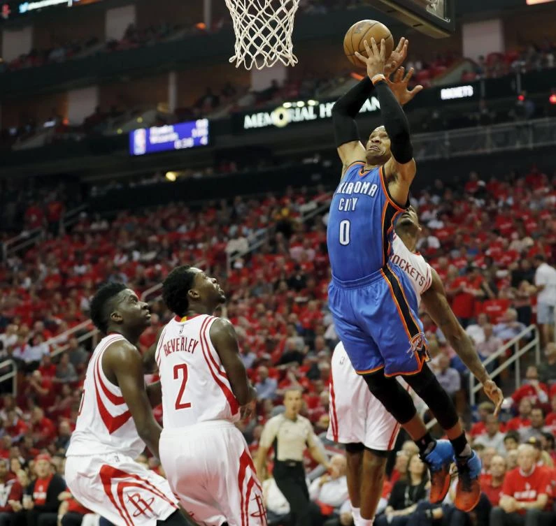 Russell Westbrook, of the Oklahoma City Thunder, goes up for a dunk defended by Trevor Ariza (partly hiden), of the Houston Rockets, in the second half of Game 2 of the Western Conference quarterfinals game during the 2017 NBA Playoffs at Toyota Center on Wednesay in Houston, Texas. (AFP)