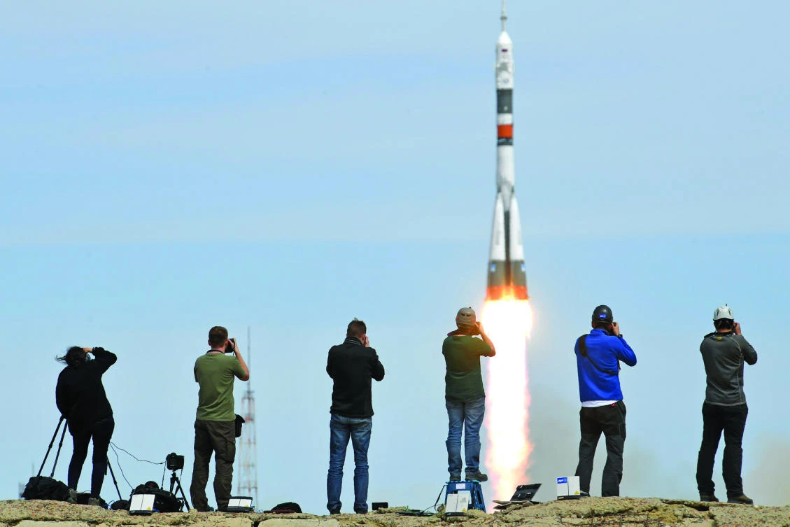 Photographers take pictures as Russia’s Soyuz MS-04 spacecraft carrying Russian cosmonaut Fyodor Yurchikhin and NASA astronaut Jack David Fischer, blasts off to the ISS from the launch pad at the Russian-leased Baikonur cosmodrome, on Thursday. (AFP)