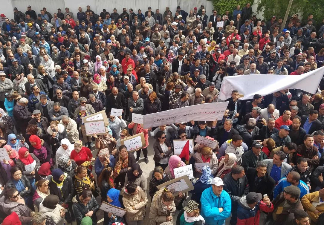 Tunisian protestors gather outside the local branch of the powerful UGTT trade union in Kef. (AFP)
