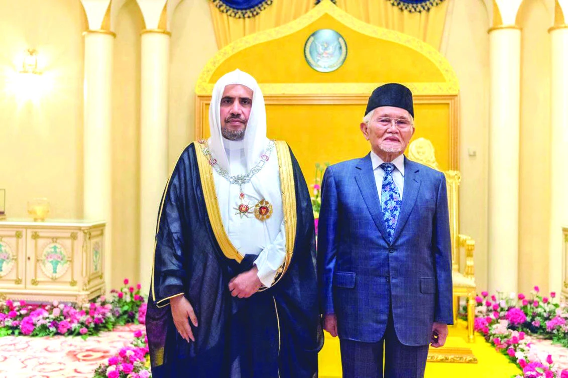 Saudi Arabia’s Mohammed bin Abdul Karim Al-Issa, secretary-general of the Muslim World League, left, receives Malaysia’s highest royal medal of honor as an appreciation for his efforts in promoting moderation.