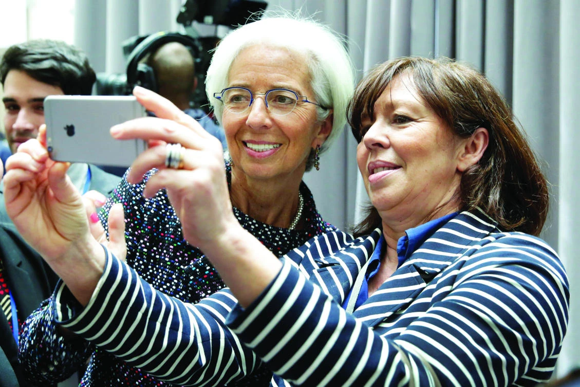 IMF Managing Director Christine Lagarde poses for a selfie with a guest in Washington. (Reuters)