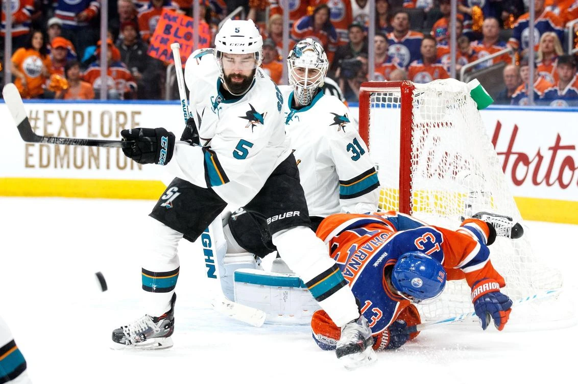 David Desharnais (13) of the Edmonton Oilers battles against David Schlemko (5) of the San Jose Sharks in Game Five of the Western Conference First Round during the NHL Stanley Cup Playoffs at Rogers Place in Edmonton, Alberta, on Thursday night. (AFP)