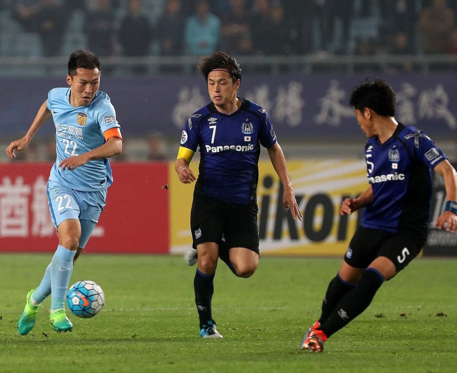 Wu Xi , left, of Jiangsu FC controls the ball, during the AFC Champions League group stage football match against Japan's Gamba Osaka, in Nanjing earlier this month. (AP)