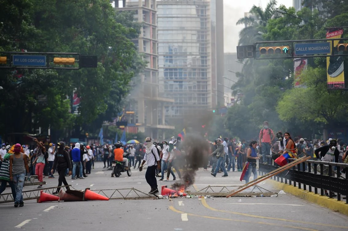 Demonstrators block a street during a protest against Venezuelan President Nicolas Maduro, in Caracas on April 20, 2017. (AFP)