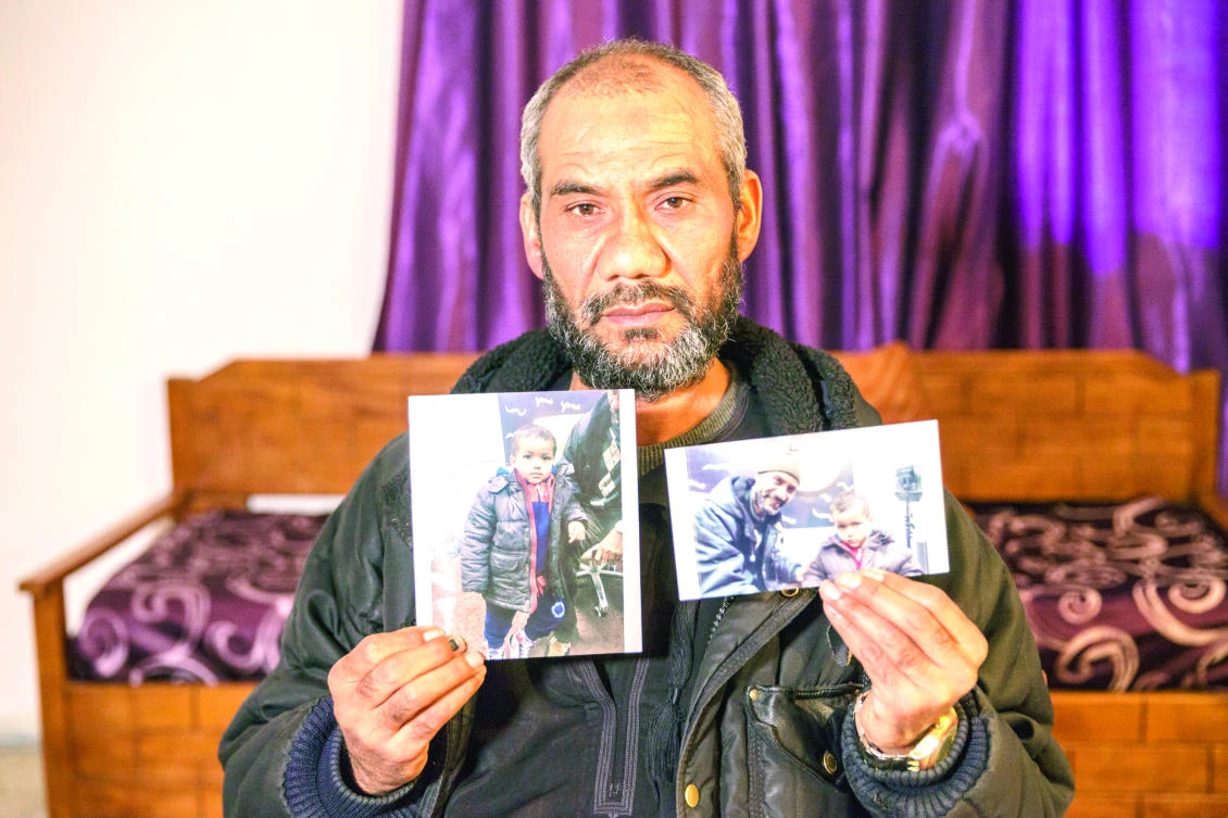 Faouzi Trabelsi shows in Tunis a photo of himself with his grandson, Tamim Jaboudi, who has been trapped in a prison in Libya since his parents, both Tunisians, who left home to join Daesh, died in a US airstrike in February 2016. (AP)