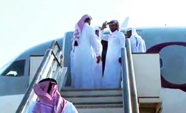 An image grab taken from a handout video released by the Iraqi Interior Ministry on Friday, shows Qatari men who were kidnapped while hunting in southern Iraq in 2015 boarding a plane at Baghdad airport following their release. (AFP)