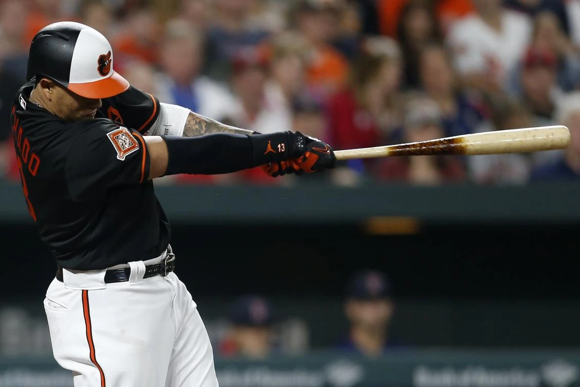 Manny Machado, of the Baltimore Orioles, hits a solo home run in the fifth inning against the Boston Red Sox at Oriole Park at Camden Yards on Friday in Baltimore, Maryland. (AFP)