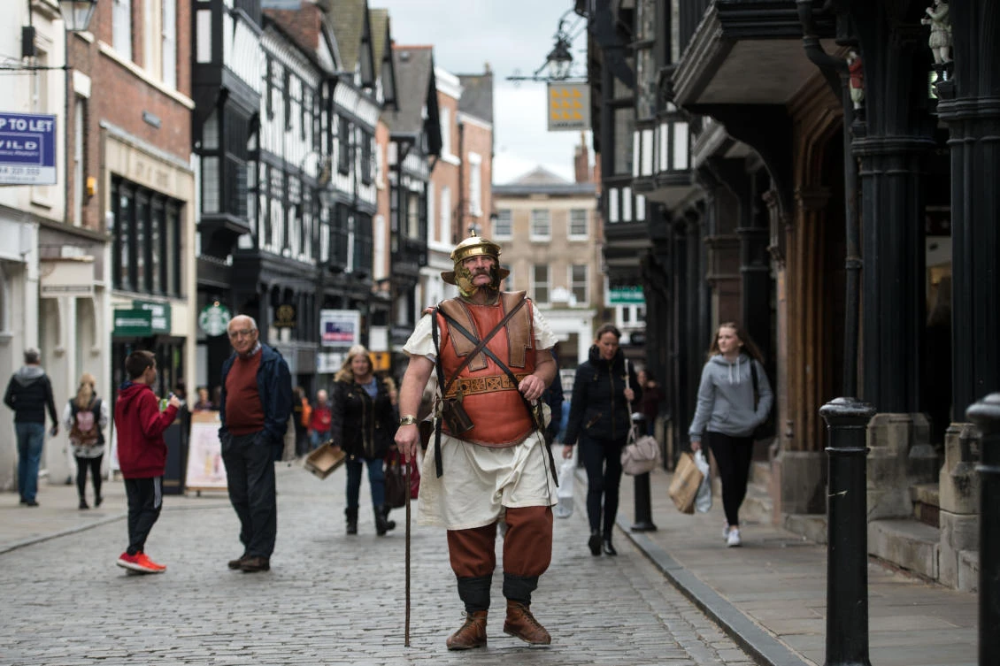A reenactor dressed as a Roman soldier makes his way through the city centre of Chester, northern England. (AFP)