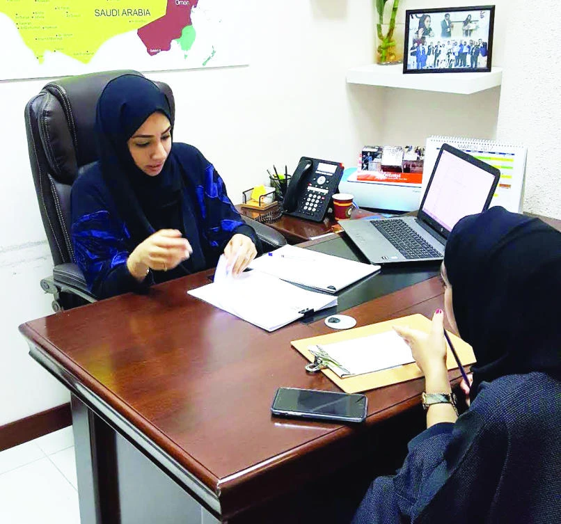 Saudi women work at a REDTAG office.