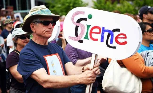Dan Stofle holds up a sign while participating in the March for Science in San Francisco, California on Saturday. (AFP)