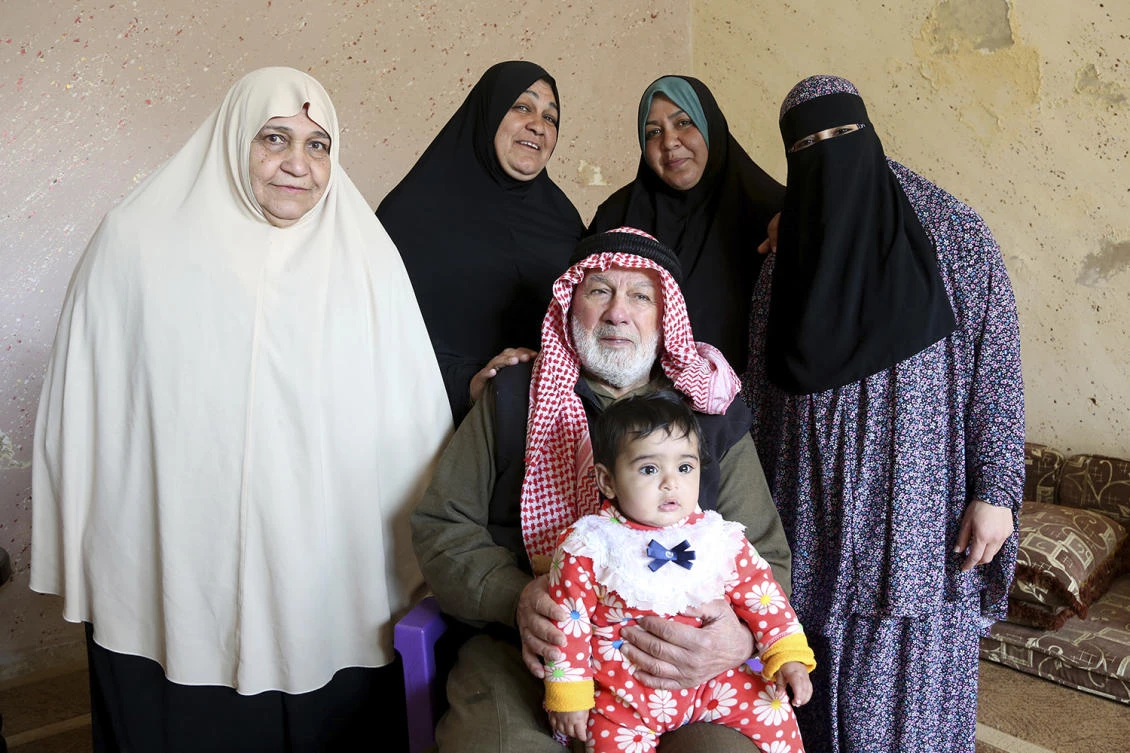 In this photo taken Wednesday, Feb. 18, 2017, five generations of a Palestinian refugee family, the Abu Massouds, pose for a portrait. From left to right (standing): Bassama Abu Massoud, 72; her daughter Hanaa, 50; Hanaa's daughter, Abir, 33; Abir's daughter, Ala, 18. Patriarch Abdullah Abu Massoud, 77, sits in a chair, holding his 9-month-old great-great-granddaughter, Tuqaa, in his lap. (AP)