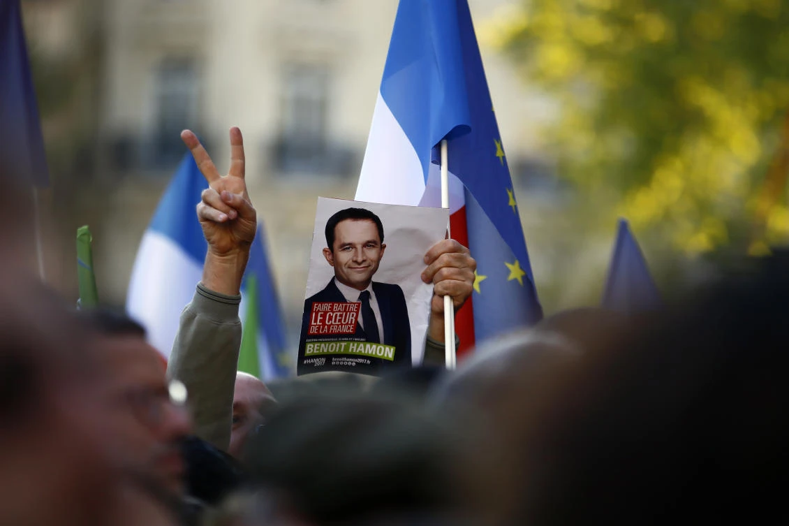 A supporter holds a leaflet of French Socialist presidential candidate Benoit Hamon during a last-ditch rally and concert in Paris. (AP)
