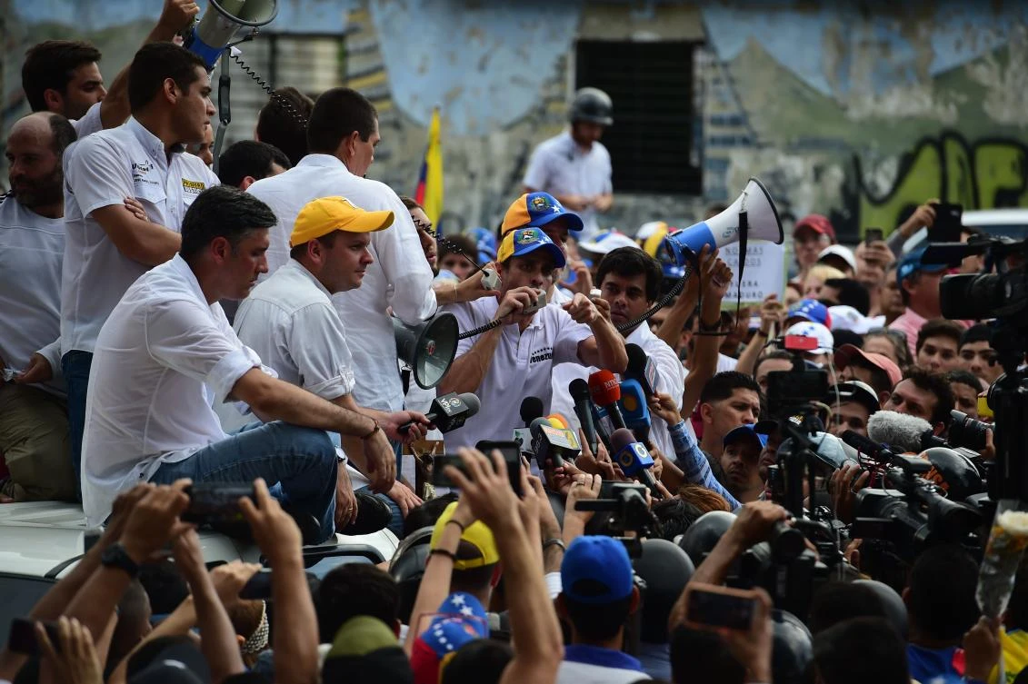 Venezuelan opposition activists march to the Catholic Church's episcopal seat in a quiet show of condemnation of the government of President NIcolas Maduro, in Caracas. (AFP)