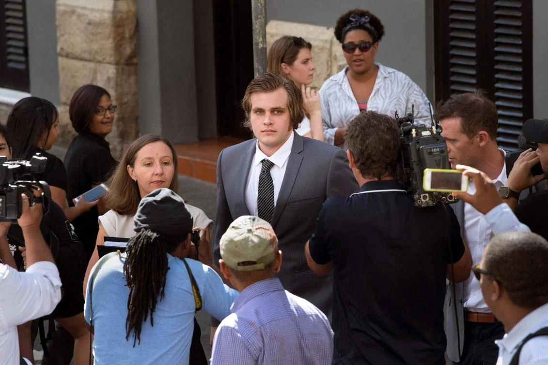 Shows Henri van Breda (C) arriving with his lawyer Lorinda van Niekerk (L) at the Western Cape High Court. (AFP)