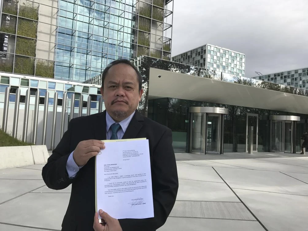 Lawyer Jude Sabio from the Philippines poses for a portrait as he holds a 77-page file outside the International Criminal Court in The Hague, Netherlands, Monday, April 24, 2017. (AP)
