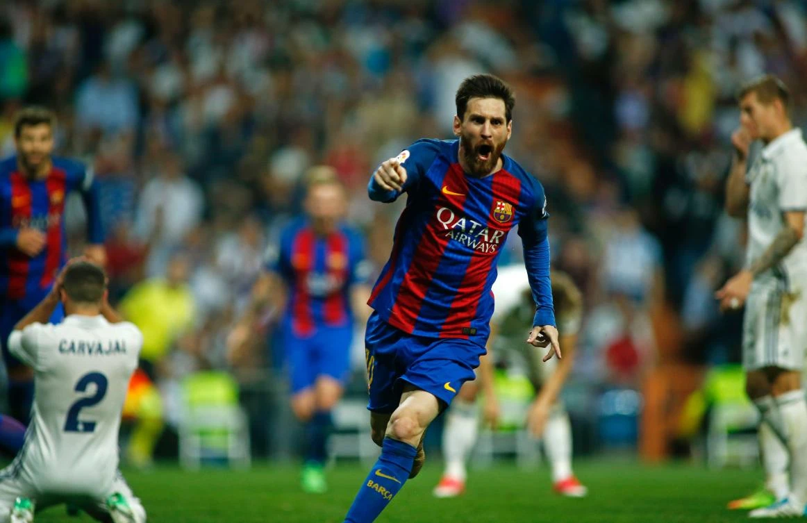 Barcelona's Argentinian forward Lionel Messi celebrates after scoring during the Spanish league Clasico football match Real Madrid CF vs. FC Barcelona at the Santiago Bernabeu stadium in Madrid on Sunday. (AFP)