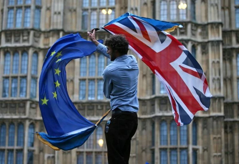 A man waves both a Union flag and a European flag together on College Green outside The Houses of Parliament at an anti-Brexit protest in central London on June 28, 2016
Justin Tallis. (AFP)