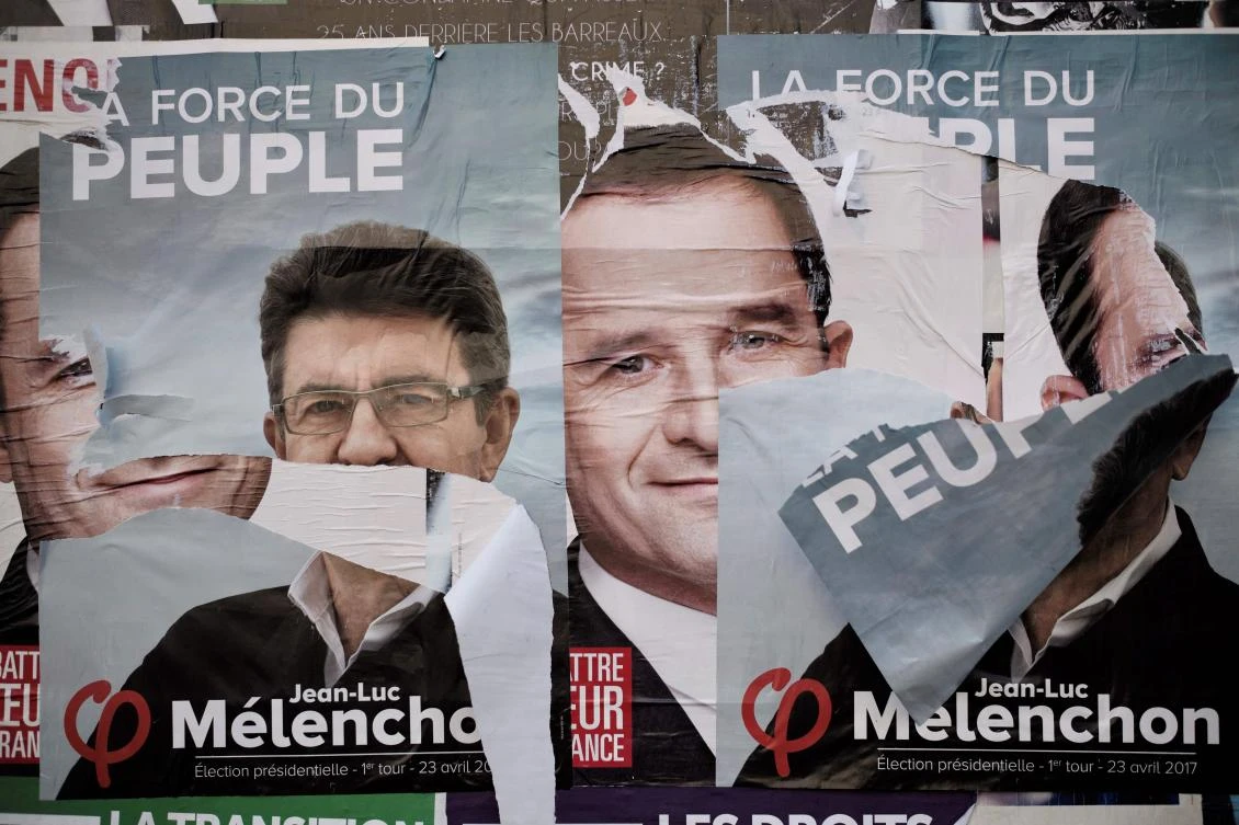 Ripped campaign posters of French presidential election candidates. (AFP)