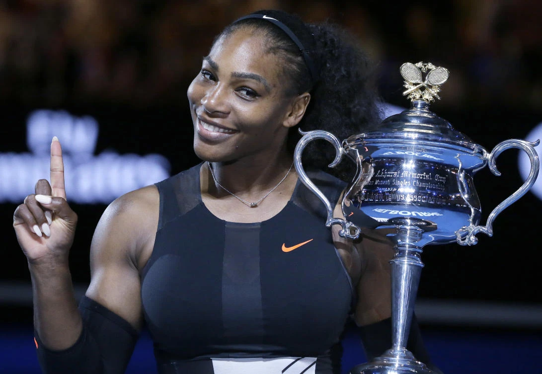 In this Jan. 28, 2017, file photo, Serena Williams holds up a finger and her trophy after defeating her sister, Venus, in the women’s singles final at the Australian Open tennis championships in Melbourne, Australia. (AP)