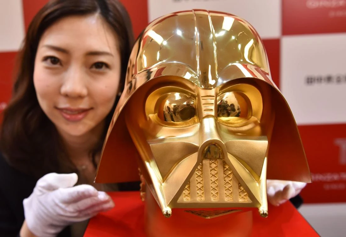 An employee of Japan's jeweler Tanaka Kikinzoku Jewelry displays a pure gold life size mask of Darth Vader, a character in the Star Wars, at their main shop in Ginza shopping district in Tokyo on April 25, 2017. (AFP)