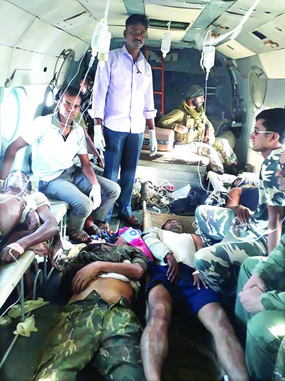 Wounded Indian security personnel are treated in an army helicopter in Sukma district of Chhattisgargh state on Tuesday. (AFP)