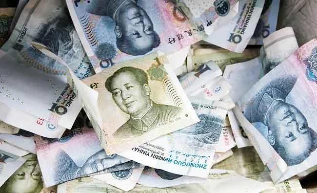 Chinese Yuan bank notes are seen at a vendor's cashbox at a market in Beijing, in this April 10, 2013 file photo. (REUTERS)