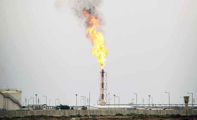 A photo taken on April 17, 2017 shows flames rising from the burning of excess oil at the West Qurna-2 oilfield, west of Basra in southern Iraq. (AFP)
