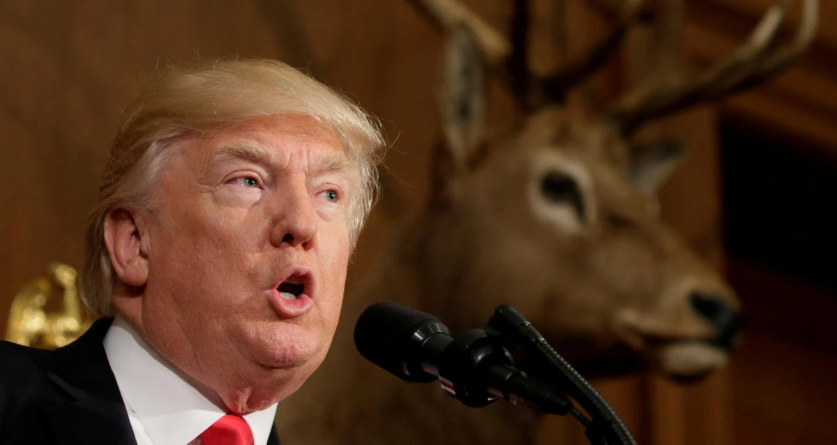 Under a mounted deer, U.S. President Donald Trump speaks before signing the Antiquities Executive Order at the Department of the Interior in Washington, DC, U.S. April 26, 2017. REUTERS/Kevin Lamarque TPX IMAGES OF THE DAY