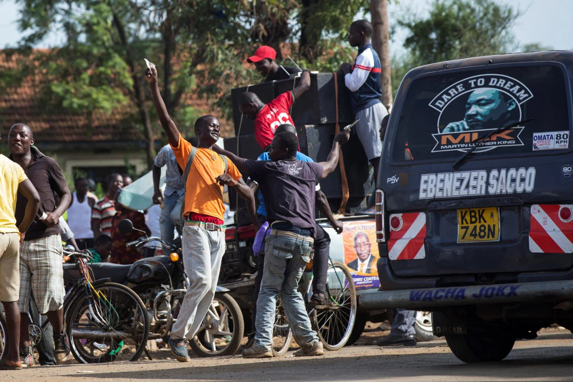 Kenyans dance while holding money after a primaries election event in Kisumu. (Reuters)