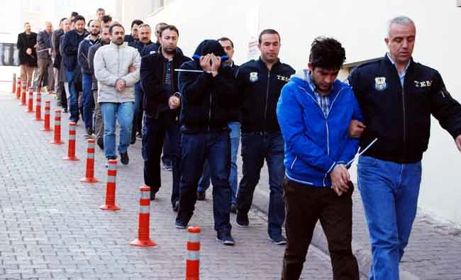 Police officers escort people, arrested because of suspected links to US-based cleric Fethullah Gulen, in Kayseri, Turkey.(AP)