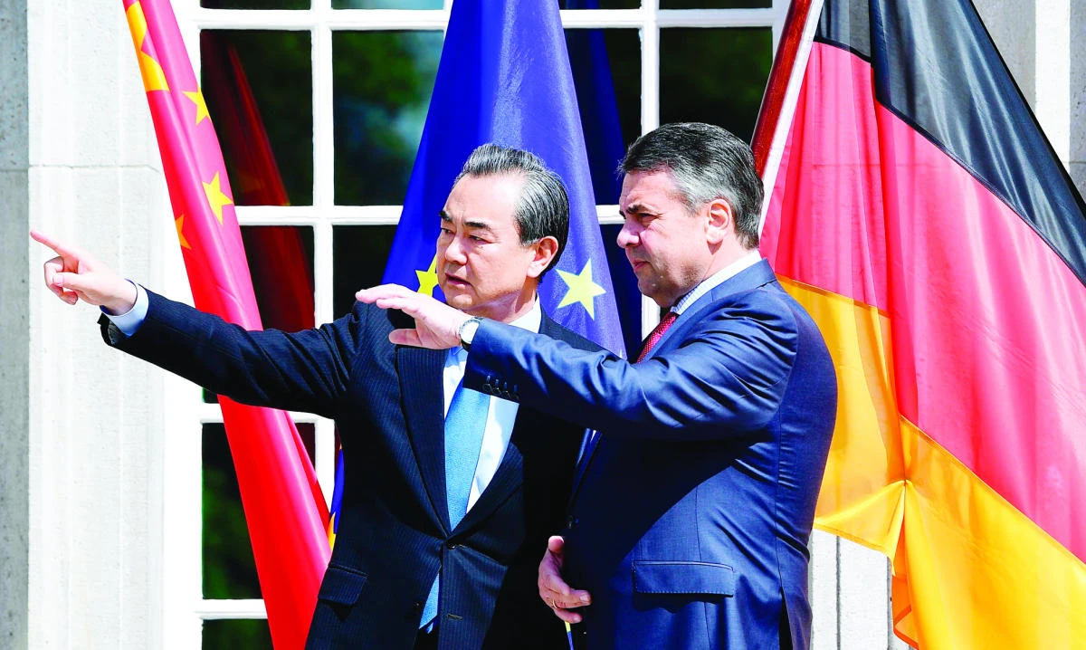 German Foreign Minister Sigmar Gabriel, right, welcomes Chinese Minister of Foreign affairs Wang Yi for talks at the Borsig villa in Berlin on Wednesday. (AFP)