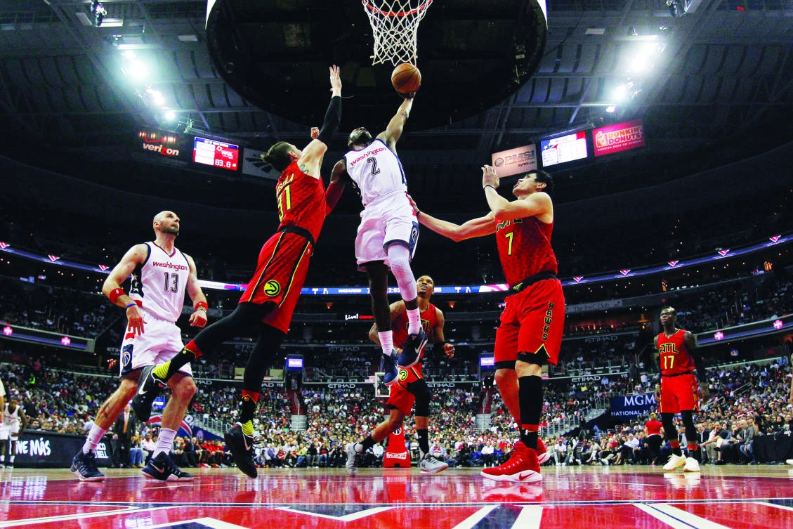 Washington Wizards guard John Wall dunks the ball over Atlanta Hawks forward Mike Muscala (31) in the fourth quarter in game five of the first round of the 2017 NBA Playoffs at the Verizon Center on Wednesday. (USA TODAY Sports)