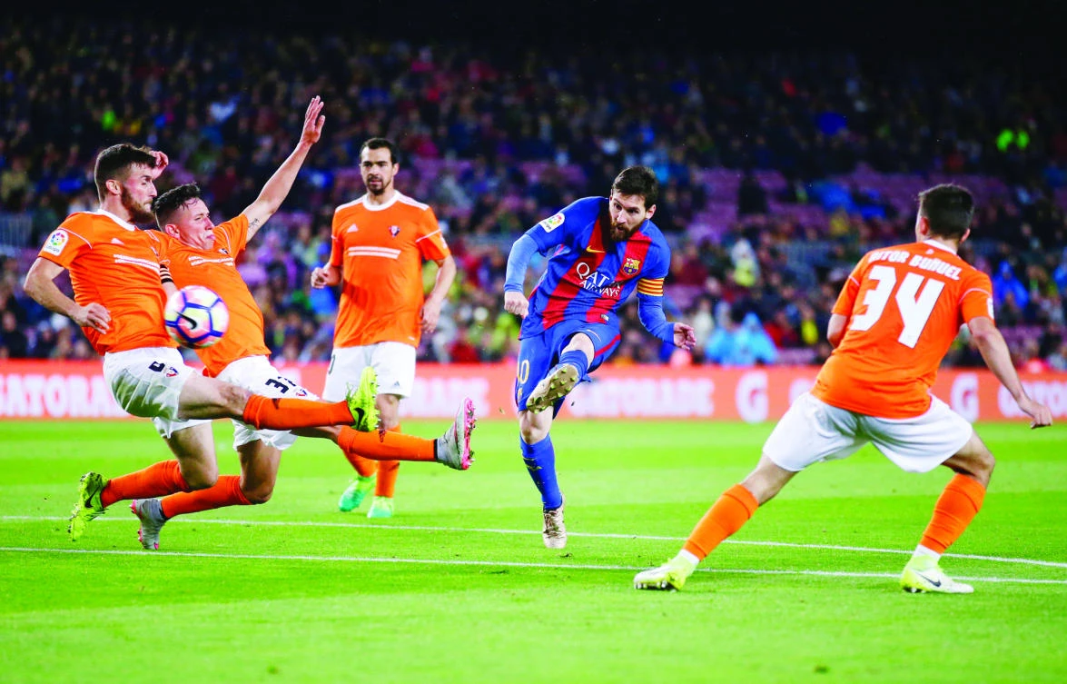 FC Barcelona’s Lionel Messi, second right, kicks the ball to score during the Spanish La Liga soccer match between FC Barcelona and Osasuna at the Camp Nou stadium in Barcelona, Spain, Wednesday. (AP)