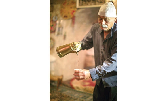 Druze man serves coffee.
