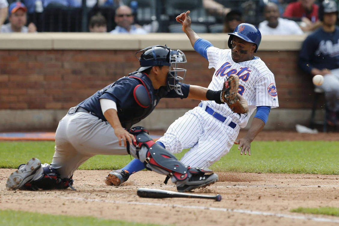 New York Mets center fielder Curtis Granderson (3) beats the throw to Atlanta Braves catcher Kurt Suzuki (24) in the ninth inning at Citi Field on Thursday. (USA TODAY Sports)