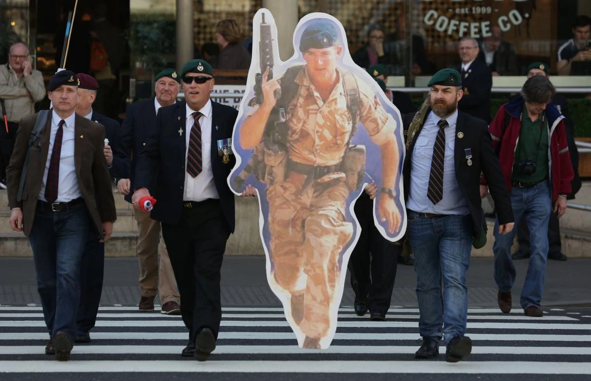 Supporters of jailed former British soldier Alexander Blackman (cut out), Marine A, arrive at The Royal Courts of Justice in London. (AFP)