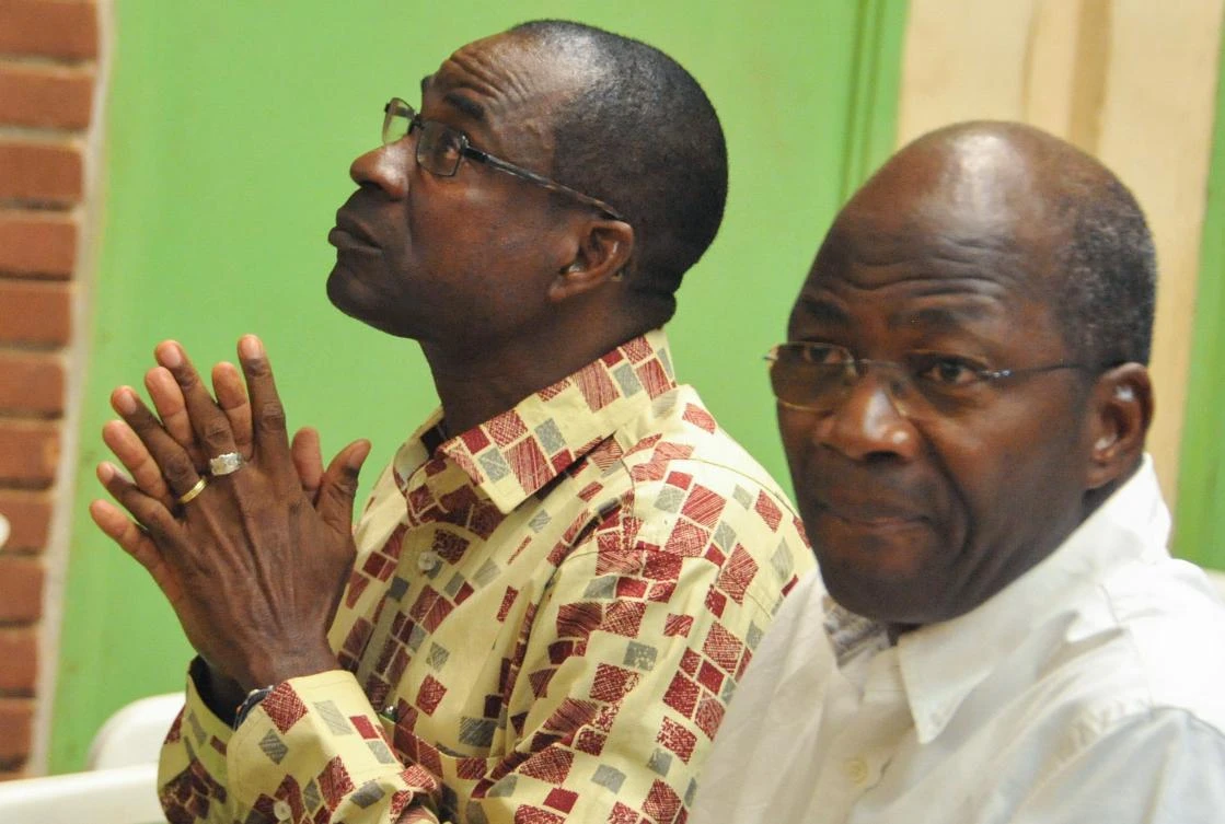 Burkina Faso’s former Foreign Minister Djibril Basole, left, sits next to the former head of the presidential security Gen. Gilbert Diendere, as they wait for the opening of the trial of the former president and members of his last government, in Ouagadougou on Thursday. (AFP)