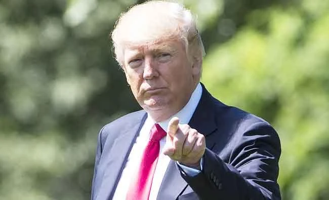 US President Donald Trump walks to Marine One prior to departing from the South Lawn of the White House in Washington, DC, on Friday, as he travels to Atlanta, Georgia. (AFP)