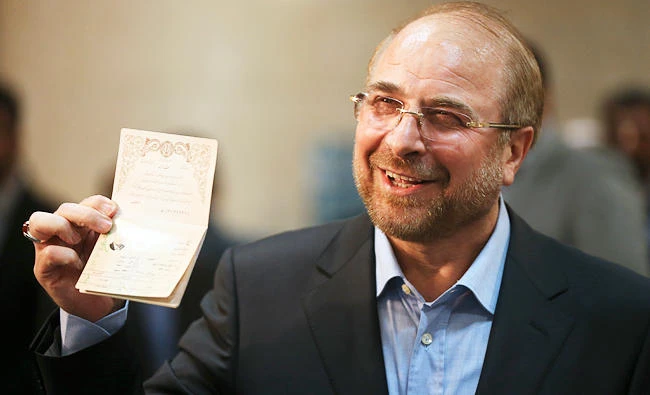Tehran Mayor Mohammad Bagher Qalibaf shows his identification to media while attending at the Interior Ministry to register his candidacy for the May 19 presidential elections in Tehran, Iran, in this photo taken on April 15, 2017. (AP)