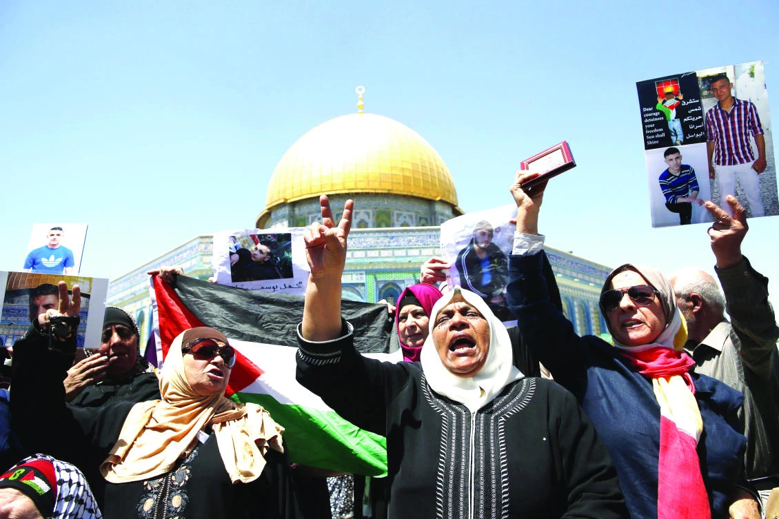 Families of Palestinians imprisoned in Israeli jails protest Friday outside the Dome of the Rock at Al-Aqsa Mosque compound in Jerusalem’s Old City. (AFP)