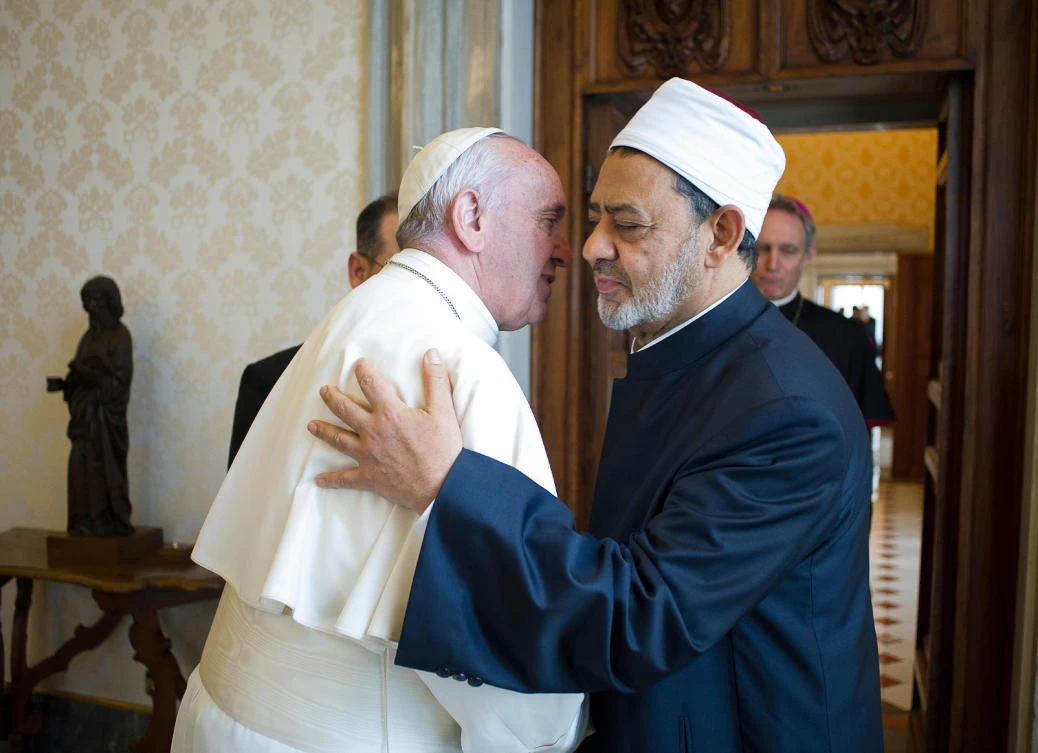 (FILES) This file handout photo released by the Vatican press office on May 23, 2016 shows Pope Francis (L) embracing Egyptian Grand Imam of al-Azhar Mosque Sheikh Ahmed Mohamed al-Tayeb (R), during a private audience at the Vatican. (AFP)