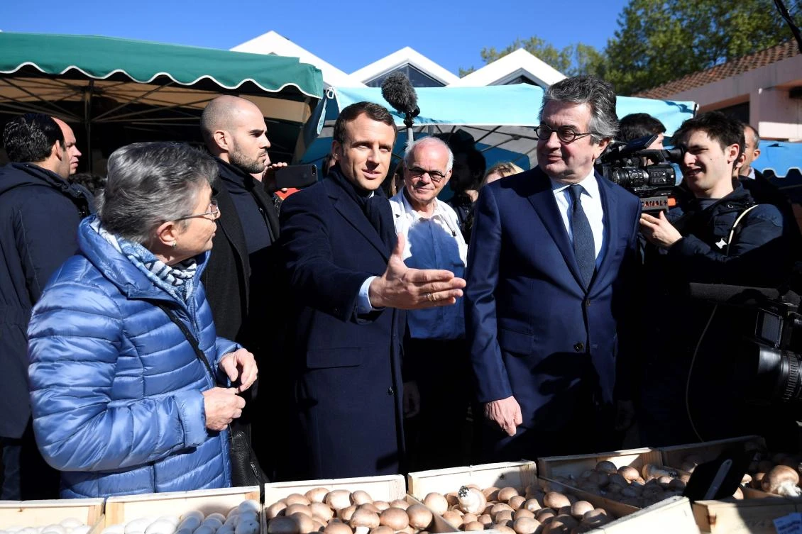 French presidential election candidate Emmanuel Macron meets people at a market in Poitiers, central France. (AFP)