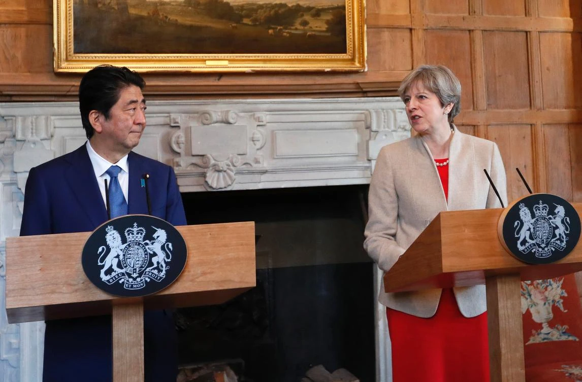 Britain's Prime Minister Theresa May (R) delivers a statement alongside Japan's Prime Minister Shinzo Abe (L) at Chequers, near Ellesborough. (AFP)